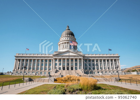 Garden at entrance of State Capitol building in Salt Lake city. View of national government built structure with clear blue sky in background. Famous political landmark in city during sunny day. Garden at entrance of State Capitol building in Salt Lake city. View of national government built structure with clear blue sky in background. Famous political landmark in city during sunny day. 95062740
