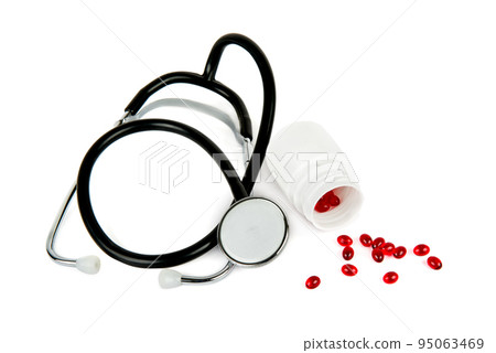 Stethoscope and pills isolated on white . 95063469