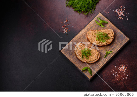 Homemade meat snack liver pate with toast on a dark concrete background Homemade meat snack liver pate with toast on a dark concrete background 95063806