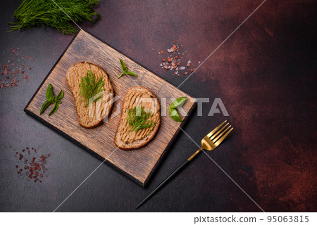 Homemade meat snack liver pate with toast on a dark concrete background 95063815