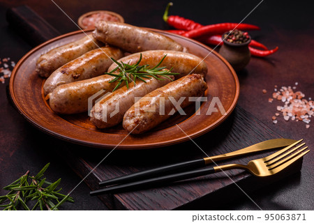 Roasted sausages grill with spices and herbs with salt and pepper Roasted sausages grill with spices and herbs with salt and pepper 95063871