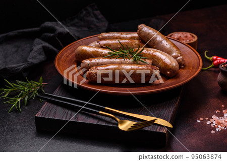 Roasted sausages grill with spices and herbs with salt and pepper 95063874