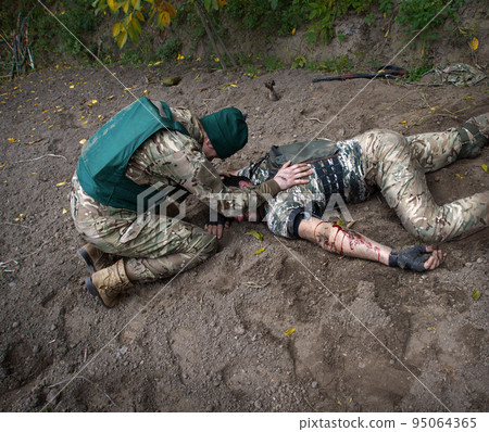 The friend cries at wounded soldier 95064365