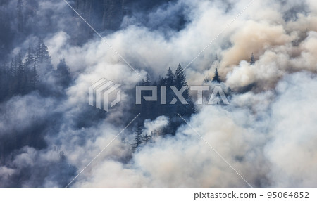 BC Forest Fire and Smoke over the mountain near Hope during a hot sunny summer day. 95064852