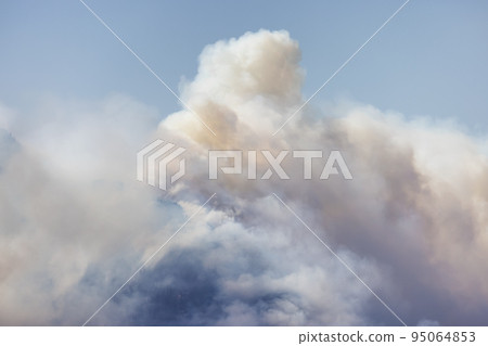 BC Forest Fire and Smoke over the mountain near Hope during a hot sunny summer day. 95064853