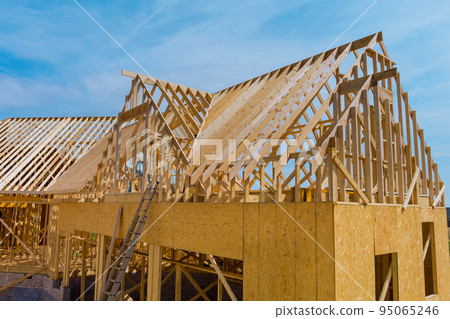 New residential construction beams framing home wooden building frame structure on of under construction New residential construction beams framing home wooden building frame structure on of under construction 95065246