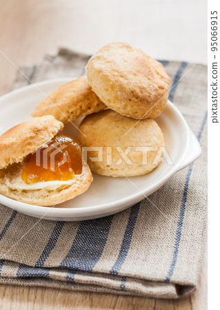 scones with butter and jam on a napkin and Bank of jam 95066915