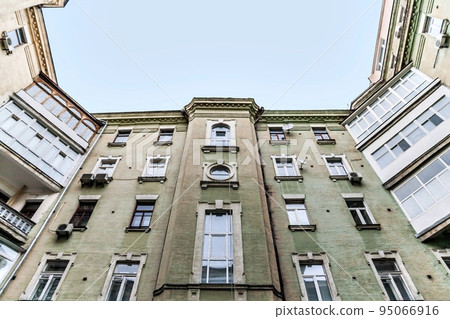 view from the bottom up at the sky, tall old houses, wells, balconies 95066916