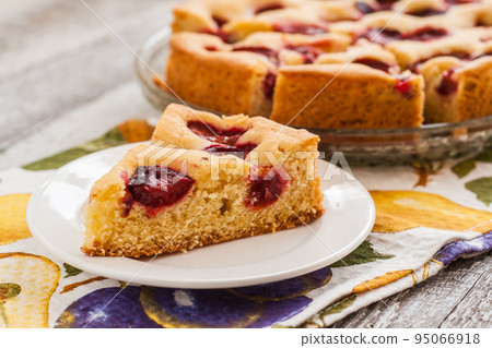 pie with plums and slice and cup with coffee pie with plums and slice and cup with coffee 95066918