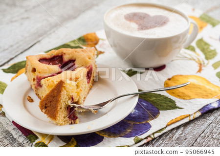 pie with plums and slice and cup with coffee pie with plums and slice and cup with coffee 95066945