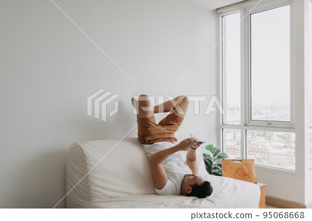 Funny man using phone in a boring time. Concept of time and boring. 95068668