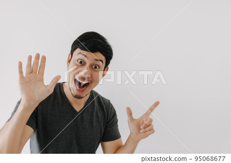 Wow surprise shock face man in black t-shirt isolated on white background. 95068677