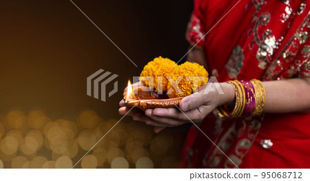 Traditional diya lamps lit during diwali celebration Traditional diya lamps lit during diwali celebration 95068712