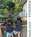 girl sisters looking hard at animals 95068900
