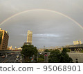A view of the city with a beautiful rainbow 95068901