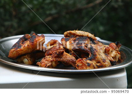 Vegetables , meat and fish are grilled on hot coals . 95069470
