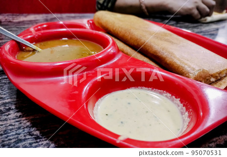 Masala dosa is a South Indian meal served with sambhar and coconut chutney. Selective focus 95070531