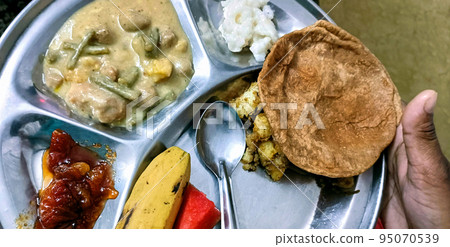 Puri sabji - Indian semi dry Potato Spicy recipe also known as Batata or Aloo ki Sabji, served with fried Poori 95070539