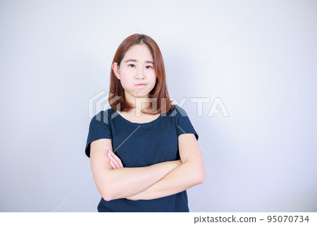 Japanese woman with a dissatisfied expression Japanese woman with a dissatisfied expression 95070734