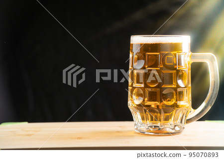 Pouring beer into the glass. Sausage with mug cold craft beer in a glass with water drops. Pint of Beer Pouring beer into the glass. Sausage with mug cold craft beer in a glass with water drops. Pint of Beer 95070893