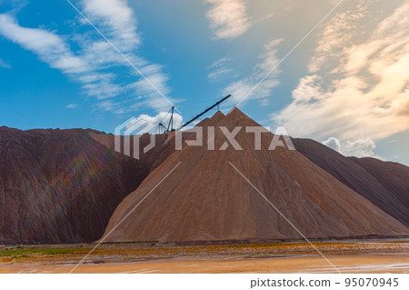 Mining industry close up. Telestacker handles the ore closeup for potash waste heaps, extraction of salt and potash fertilizers in a quarry and processing of ore 95070945