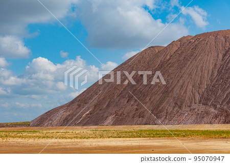 Mining industry close up. Telestacker handles the ore closeup for potash waste heaps, extraction of salt and potash fertilizers in a quarry and processing of ore 95070947