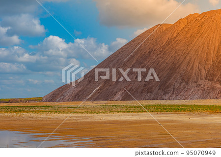 Mining industry close up. Telestacker handles the ore closeup for potash waste heaps, extraction of salt and potash fertilizers in a quarry and processing of ore Mining industry close up. Telestacker handles the ore closeup for potash waste heaps, extraction of salt and potash fertilizers in a quarry and processing of ore 95070949