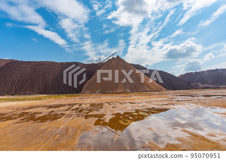 Mining industry close up. Telestacker handles the ore closeup for potash waste heaps, extraction of salt and potash fertilizers in a quarry and processing of ore 95070951