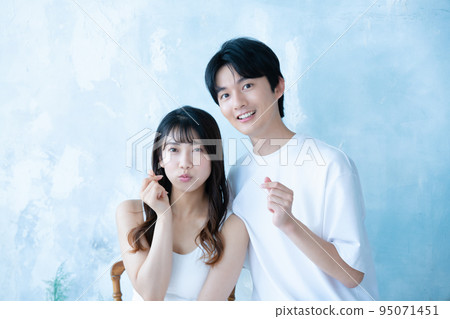 A young couple doing Kyun pose A young couple doing Kyun pose 95071451