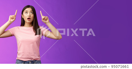 Surprised impressed asian girl brunette look fascinated up, drop jaw gasping astonished, check out impressive interesting promo, pointing top advertisement amazed, stand purple background Surprised impressed asian girl brunette look fascinated up, drop jaw gasping astonished, check out impressive interesting promo, pointing top advertisement amazed, stand purple background 95071661