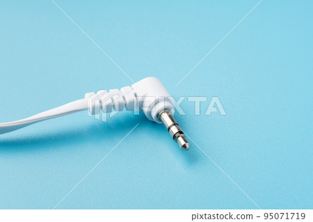 Earphone jack on light blue background 95071719