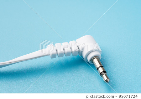 Earphone jack on light blue background 95071724