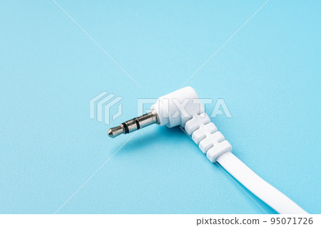 Earphone jack on light blue background 95071726