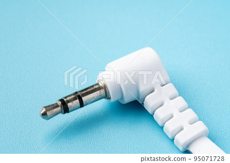 Earphone jack on light blue background 95071728