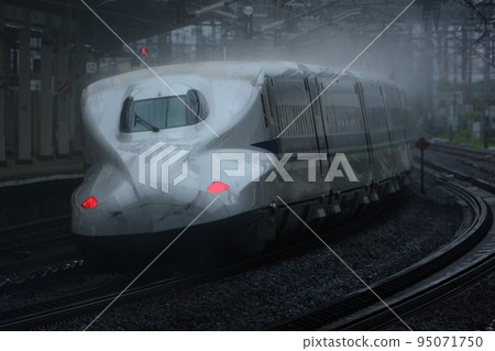 Tokaido Shinkansen N700A passing Maibara Station in the rain Tokaido Shinkansen N700A passing Maibara Station in the rain 95071750
