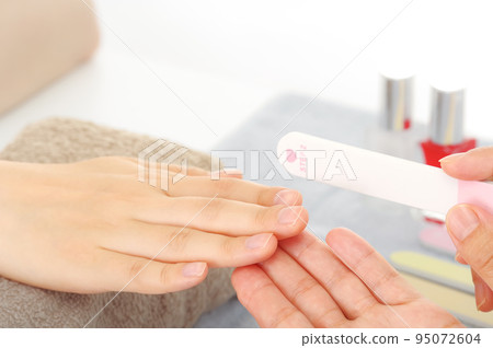 Woman doing nail care at nail salon Woman doing nail care at nail salon 95072604