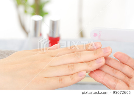Woman doing nail care at nail salon Woman doing nail care at nail salon 95072605