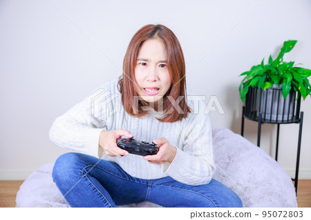 Woman desperate for video games Woman desperate for video games 95072803