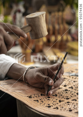 craft artist making traditional buffalo leather carving art in indonesia craft artist making traditional buffalo leather carving art in indonesia 95074436