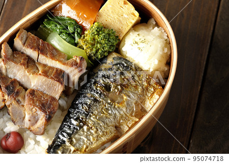 A bird's-eye view of a grilled fish bento box containing pork, potato salad, omelet, etc. A bird's-eye view of a grilled fish bento box containing pork, potato salad, omelet, etc. 95074718