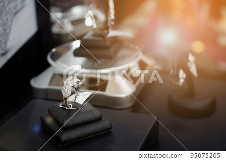Diamond rings in jewelry luxury store window display Diamond rings in jewelry luxury store window display 95075205