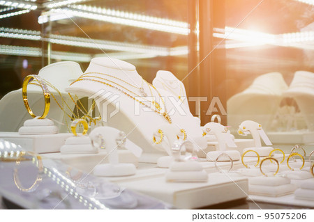 Gold jewelry diamond shop with rings and necklaces luxury retail store window display 95075206