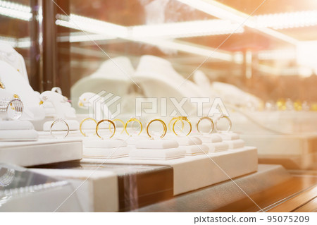 Jewelry diamond rings and necklaces show in luxury retail store window display Jewelry diamond rings and necklaces show in luxury retail store window display 95075209