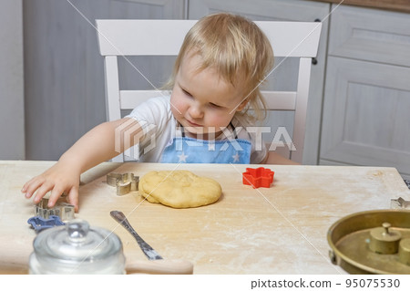 Little boy helps to bake Christmas cookies 95075530