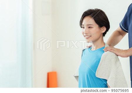 woman receiving a shoulder massage woman receiving a shoulder massage 95075695