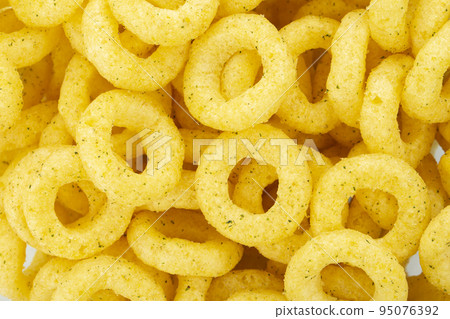 Beer snacks. Background of corn rings of sticks with cheese and green onion flavor. Beer snacks. Background of corn rings of sticks with cheese and green onion flavor. 95076392