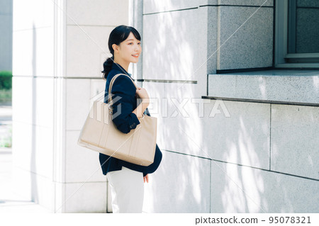 businesswoman walking in office businesswoman walking in office 95078321