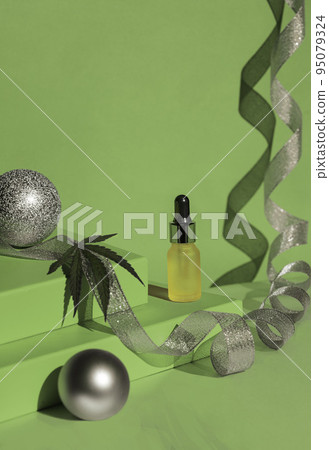 green podium of gift boxes golden ribbon. Christmas background with podium for cannabis products. cbd oil. Silver ribbon and balls green podium of gift boxes golden ribbon. Christmas background with podium for cannabis products. cbd oil. Silver ribbon and balls 95079324