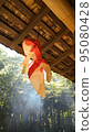 A goldfish object hung from the roof of an old folk house 95080428
