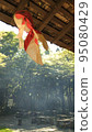 A goldfish object hung from the roof of an old folk house 95080429